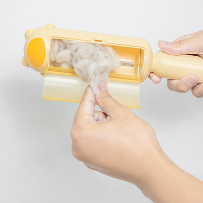 Reusable Pet Hair Remover Roller — yellow roller with open collection chamber showing collected pet hair being removed