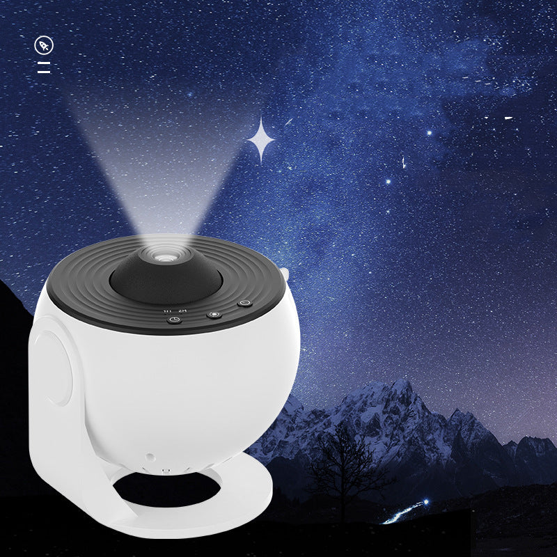Galaxy Star Projector Light — white spherical projector with black top emitting a light beam against a starry night sky with snowy mountains