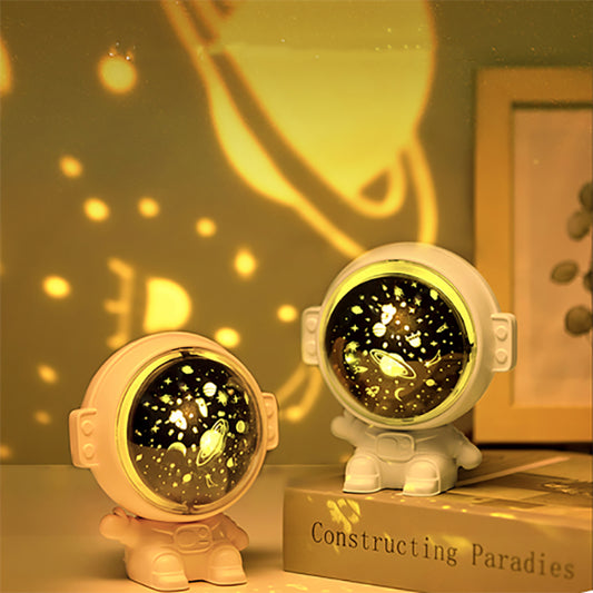 Astronaut Galaxy Star Projector Night Light — astronaut-shaped projector on a table casting a starry galaxy glow