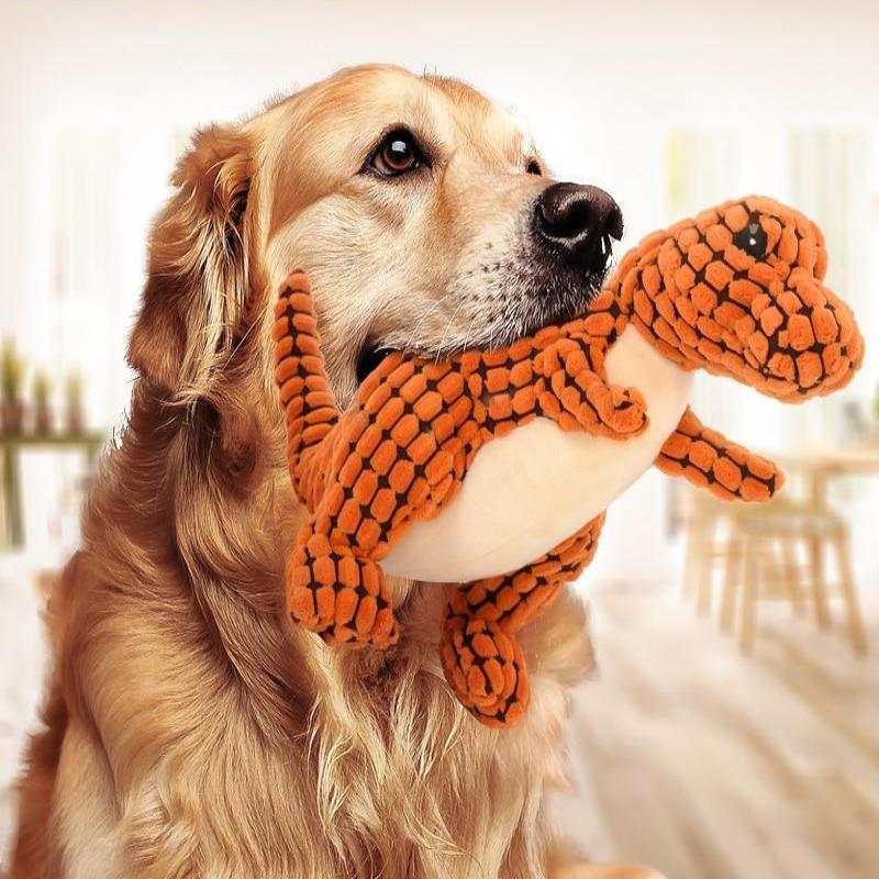 Dinosaur Plush Squeaky Dog Toy — golden retriever holding a plush dinosaur chew toy